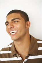 Young Hispanic man laughing