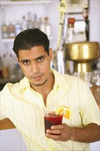 Egyptian man drinking at bar
