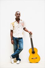 African man leaning on guitar