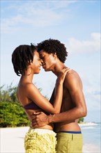 African couple kissing on beach