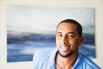 African man standing in front of painting