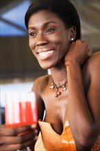 African woman drinking cocktail