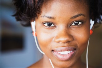 Close up of African woman wearing headphones