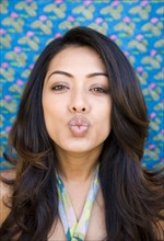 Indian woman puckering her mouth