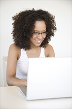 Hispanic woman using laptop