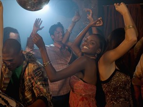 Multi-ethnic friends dancing at nightclub