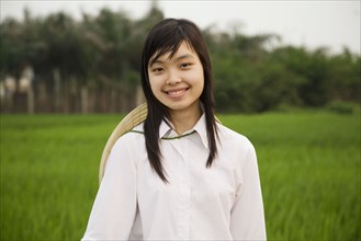 Asian woman in front of field
