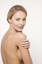 Nude Caucasian woman looking over shoulder