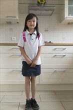 Asian girl smiling in kitchen