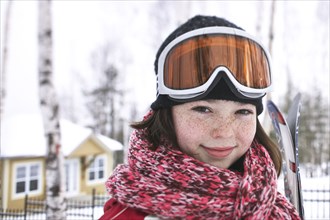 Caucasian girl wearing ski gear in snow