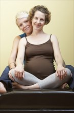Caucasian pregnant lesbian couple smiling