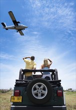 Couple admiring plane from 4x4