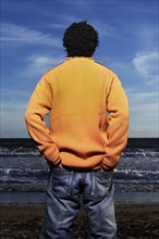 Black man standing on beach