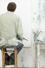 Caucasian painter working in studio
