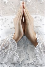 Mixed race bride's hands in prayer position