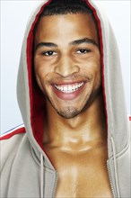 Mixed race man smiling in hoody