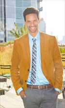 Mixed race businessman smiling outdoors