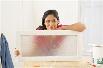Mixed race woman making window pane