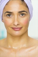 Mixed race woman wrapped in towel