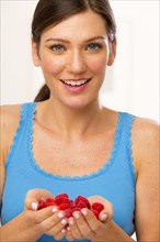 Caucasian woman holding handful of berries