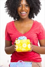 Mixed race woman holding birthday present