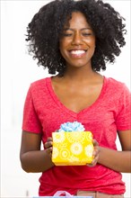 Mixed race woman holding birthday present