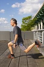 Caucasian man exercising on urban deck
