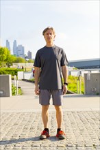 Caucasian runner standing in urban park