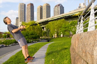Caucasian man exercising in urban park