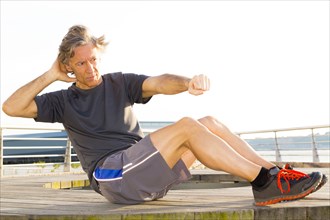 Caucasian man exercising in waterfront park