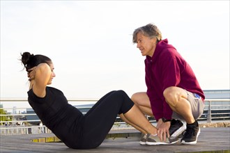 Couple exercising in waterfront park