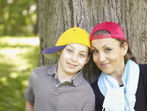 Mother and son wearing baseball caps