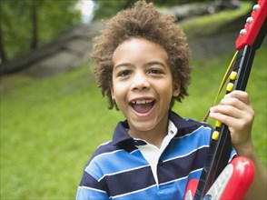 Mixed race boy with plastic guitar