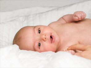 Mixed race newborn baby laying in crib