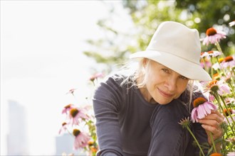 Smiling Caucasian woman holding flower