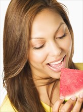 Close up of Hispanic woman eating watermelon