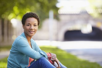 Black woman sitting outdoors