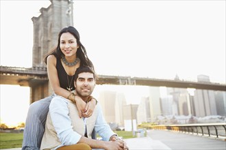 Indian couple smiling by bridge