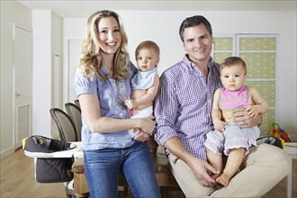 Caucasian family smiling in dining room