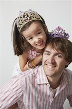 Father and daughter wearing tiaras