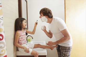 Father and daughter playing in bathroom