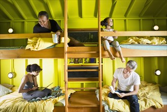 Family relaxing in bunk beds at camp