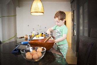 Boy cooking in kitchen