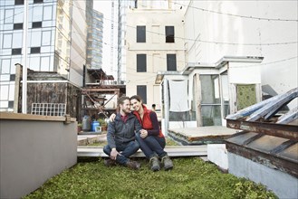 Couple smiling in urban rooftop garden