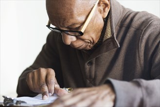 Older Black man reading notes
