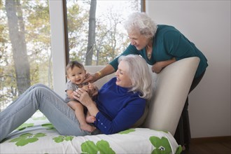 Grandmothers playing with baby grandson