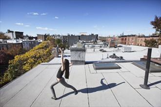 Caucasian girl dancing on rooftop