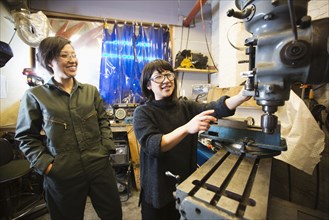 Women using machinery in workshop