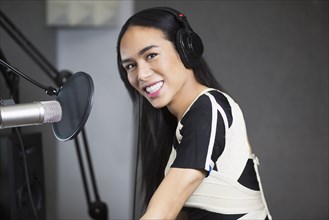 Smiling Thai transgender woman at microphone