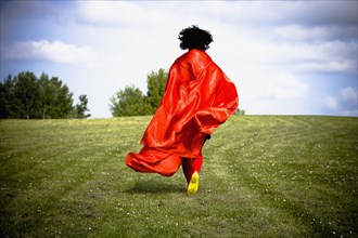 Asian woman running in field